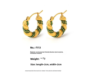 Detailed view of U-shaped gold-plated twisted rope earrings with green rhinestones