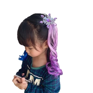 Detail of snowflake hair clip with purple to pink gradient wavy hair extensions on a girl