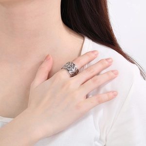 Detailed view of silver stainless steel leaf ring with sparkling white zircon stones