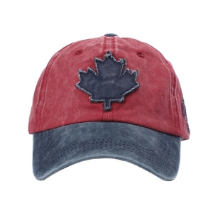 Detail of vintage washed baseball cap featuring a contrast maple leaf patch and stitching