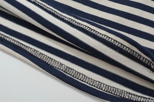 Detailed macro view showing high-density knitting and precision stitching on striped fabric
