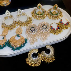 Ethnic bohemian style earring set with gold hollow drop tassels and pearls in a tray