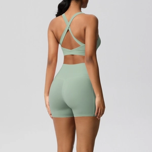 Detail of yoga set showing racerback sports bra and high-waist shorts in sage green