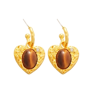 Golden heart earrings with hammered texture and brown tiger eye stone on white background