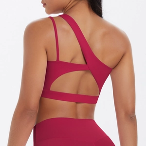Detailed back view of dark red sports bra with asymmetric straps and cut-out design
