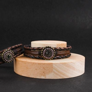 Men's multilayer braided leather bracelets with bronze pendant on wooden stands