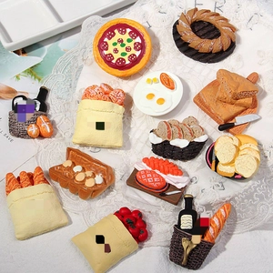 Detailed view of assorted resin bread and pizza food magnets on white lace fabric