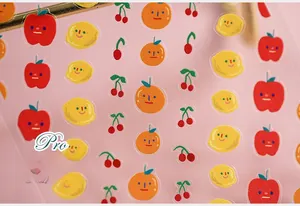 Macro shot of cute transparent fruit stickers with apple and cherry illustrations