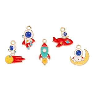 Detailed close-up of colorful enamel astronaut and rocket charms for DIY jewelry making
