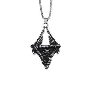 Detail shot of vintage silver Eye of Horus pendant necklace with intricate wings