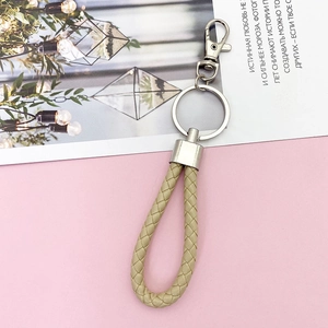 Detail of beige braided PU leather keychain with silver alloy swivel hook and ring