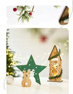 Detail of wooden Christmas star with deer cutout and glowing LED house decoration