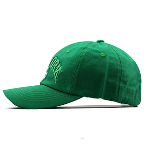 Detailed side view of green cotton baseball cap with white York 3D embroidery and stitching