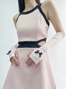 Detail of pink knitted sleeves with black bow and pearl charm on JK style fashion arm cover