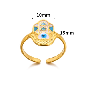 Macro shot of gold Fatima hand and evil eye ring detailing with enamel craft