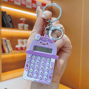 Detail of a purple milk tea cup calculator keychain with mini buttons and silver keyring