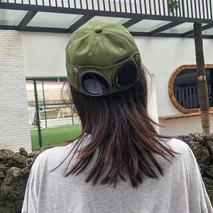 Army green baseball cap with aviator goggles on back in a trendy streetwear style