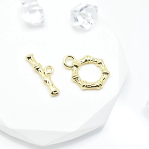Golden bamboo texture toggle clasp set on white stone for DIY jewelry making