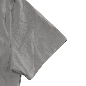 Close-up of short sleeve cuff showing grey linen fabric texture and stitching details