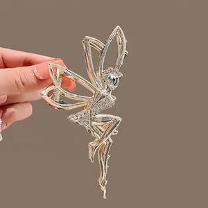 Golden angel hair claw clip with white rhinestones in a French vintage silhouette style