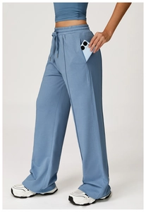 Macro detail of high-waist blue track pants with elastic drawstring and side pockets