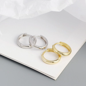 Close-up of minimalist gold and silver S925 sterling silver hoop earrings set