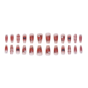 Red-brown ombre press-on nails set with black heart patterns and plaid designs