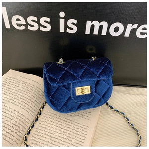 Détail du mini sac en velours bleu marine avec motif matelassé et chaîne dorée