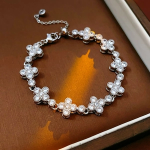 Detailed macro view of silver clover bracelet featuring micro-pave zircon stone settings
