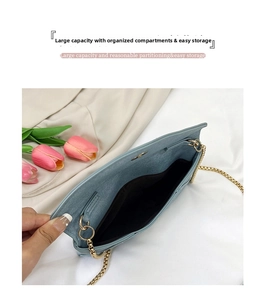 Detailed interior of light blue crossbody envelope bag showing large storage capacity