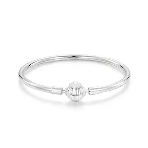 Minimalist S925 sterling silver bangle featuring a polished seashell charm on a sleek band