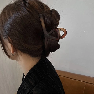 Detail view of a large amber brown matte hair claw clip for elegant women hairstyles