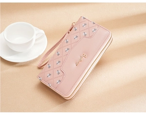 Pink diamond-stitched long clutch wallet with floral embroidery and wrist strap detail