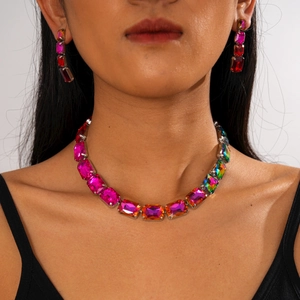 Macro detail of geometric crystal jewelry set with multicolor square stones on model