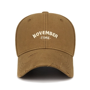 Distressed brown baseball cap with November Time embroidery and ripped brim detail