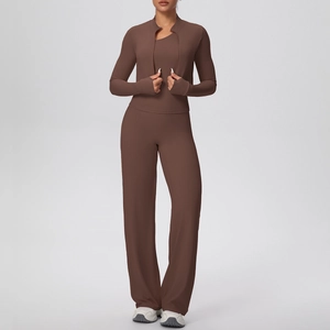 Detail of dark brown yoga set featuring jacket thumbholes and high waist trousers