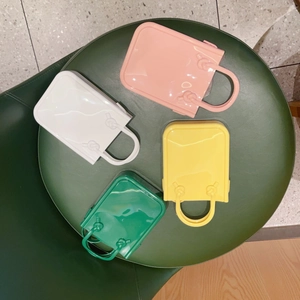 Detail view of colorful PVC jelly handbags in white pink yellow and green colors