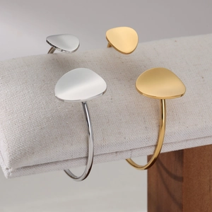 Minimalist C-shaped open bangles in gold and silver finish with flat geometric design