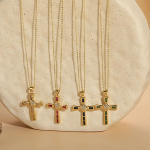 Detail of four hip-hop cross necklaces with gold finish and colorful zircon gemstones