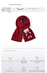 Detail of red knitted scarf with cute teddy bear doll and dimensions 160cm x 19cm