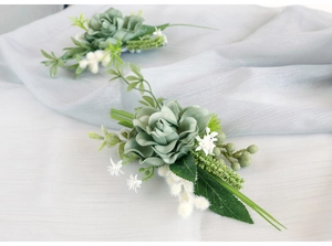 Close-up of elegant grey-green artificial rose boutonniere for wedding and ceremonies