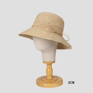 Detail of 8cm brim raffia sun hat with bow decoration on a mannequin head