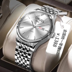 Detail of silver stainless steel business watch showing day and date display on dial