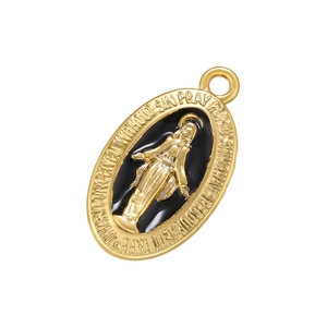 Detailed macro view of gold-plated Virgin Mary pendant with black enamel inlay
