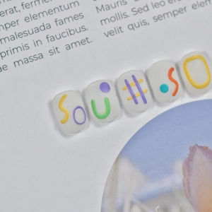 Macro shot of 5D embossed nail stickers featuring colorful 3D letters and symbols