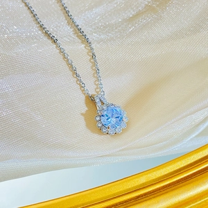 Elegant floral sun necklace with blue crystal pendant and sparkling white diamonds