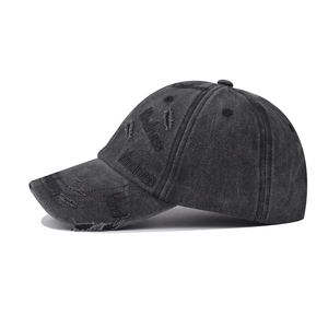 Distressed washed baseball cap with Kindness embroidery and ripped details in charcoal grey