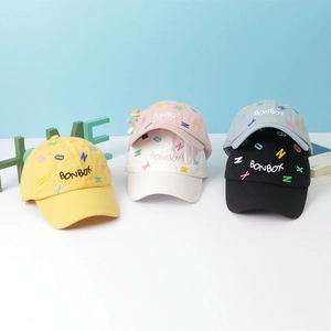 Detailed embroidery of BONBOX text on various colorful cotton canvas kids baseball caps