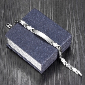 Macro shot of silver stainless steel bar bracelet on a luxury jewelry gift box