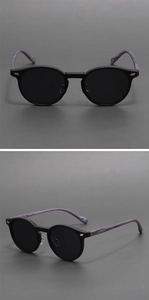 Detail view of round matte black sunglasses with purple marbled temples and metal hinges